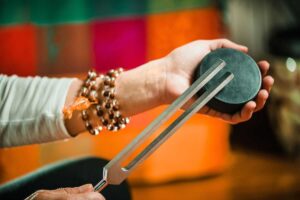 Woman holding a tuning fork during sound healing training courses in Australia